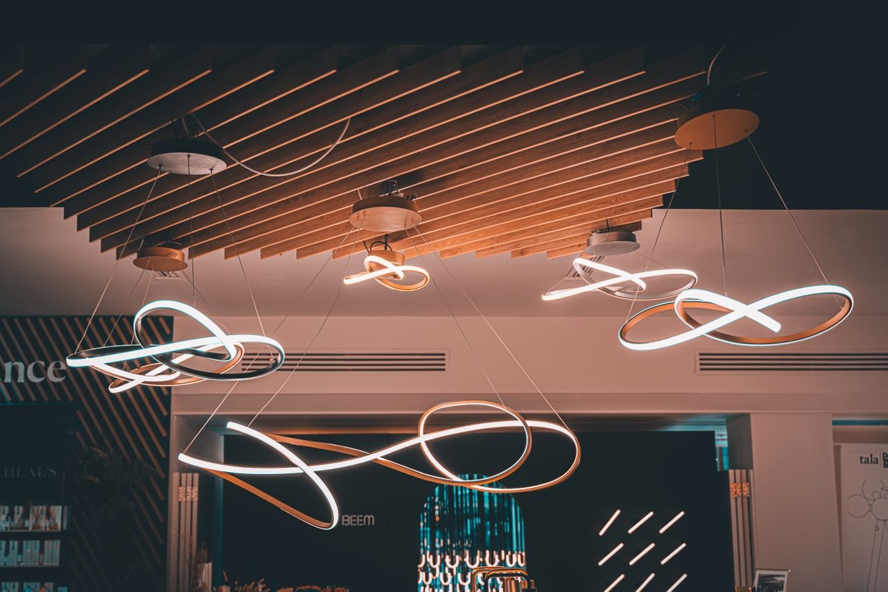 Elegant spiral hanging lights with a modern design in a London interior space.